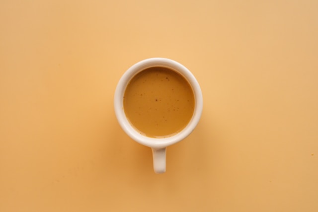 Coffee mug on brown background